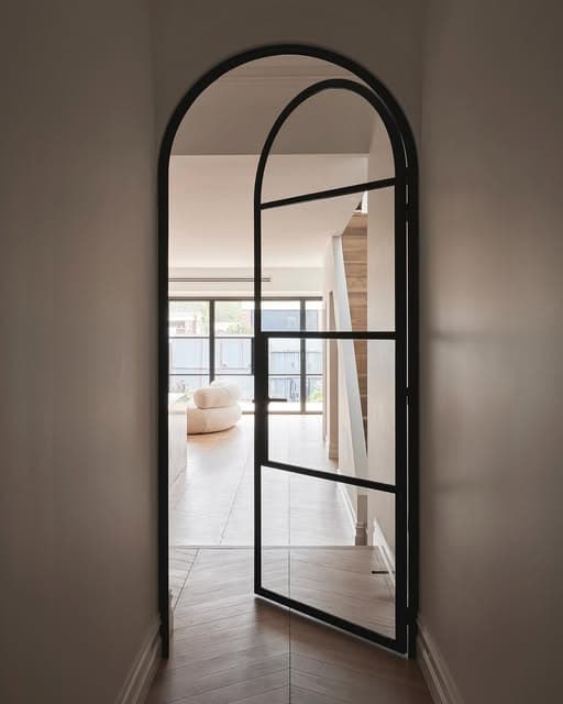 Arched aluminium glass door in a contemporary interior